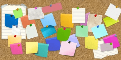 National Association of Neighborhoods A cork board covered in many different colored sticky notes.